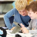 Two boys doing school work together. what does independent mean at Quintilian School