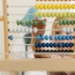 Early Learning at Quintilian School | Closeup of Young child using abacus