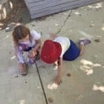 Two students working together at pavement drawing. Being a good buddy | Buddy system at Quintilian School