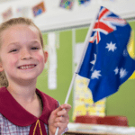 school kid holding Australian flag
